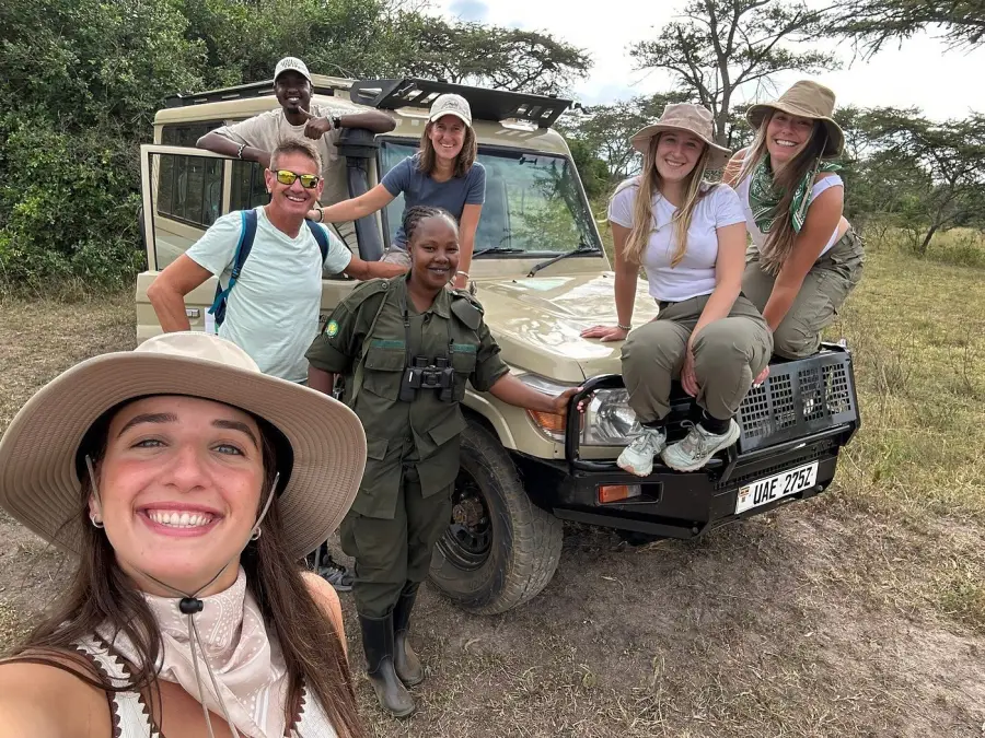 Women travellers with their guide on a safari vehicle